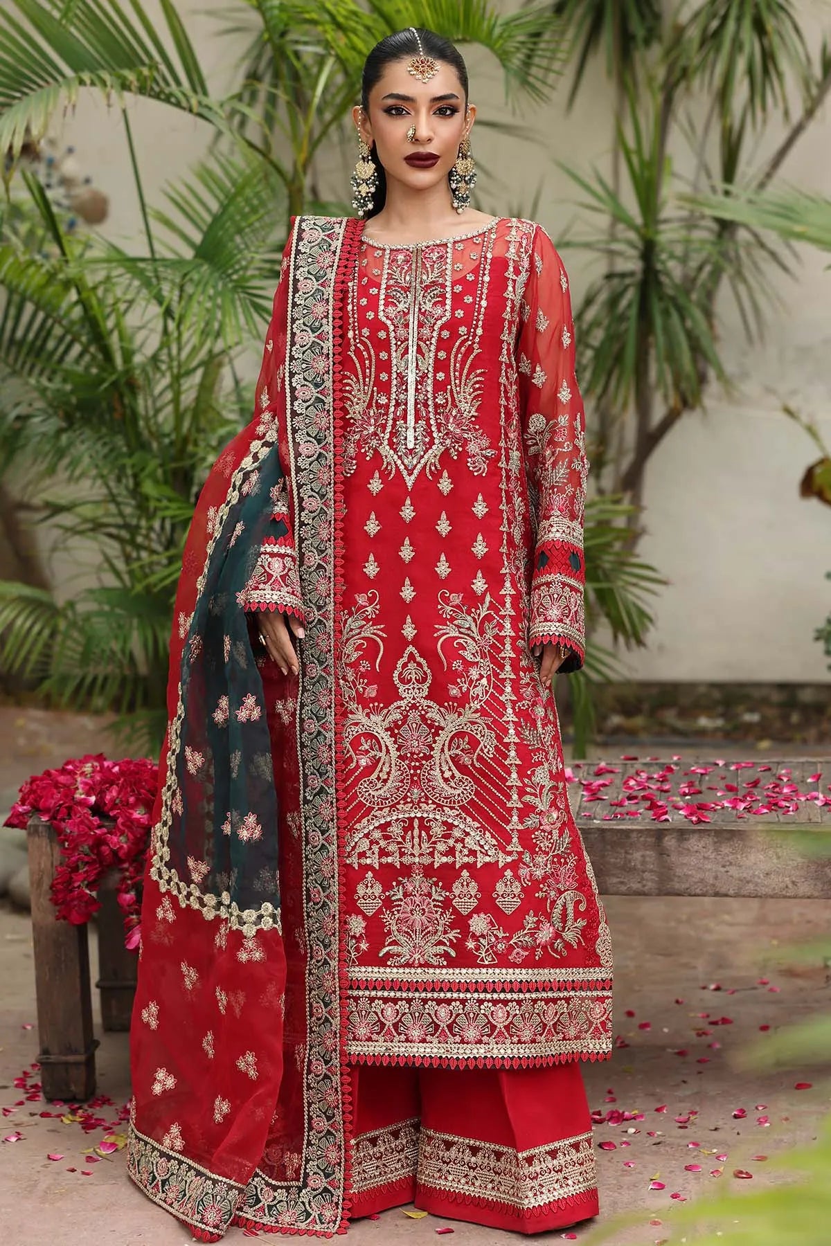 Woman wearing a red embroidered traditional outfit with a floral background