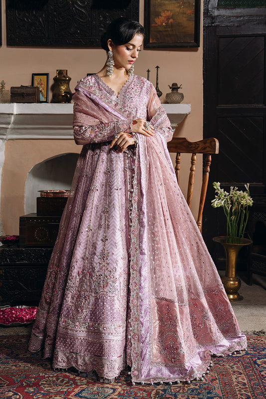 Front view of a model wearing a soft lilac-pink Nikkah dress with intricate silver embroidery, a heavily embellished flared silhouette, and a matching sheer dupatta.