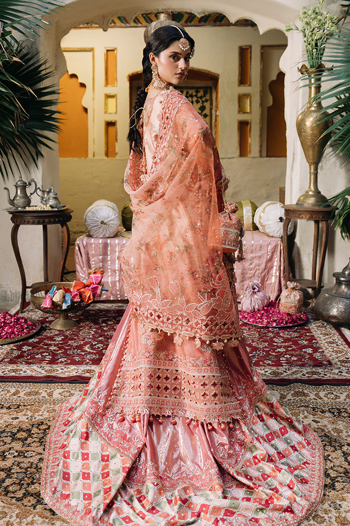 Back view of a peach pink Nikkah dress with intricate embroidery, embellished dupatta and detailed bridal lehenga.