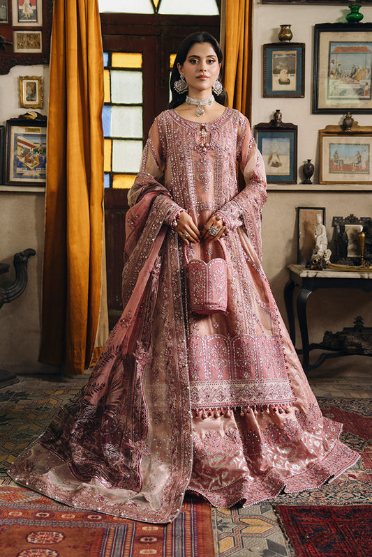 Model wearing a dusty rose Nikkah dress with intricate silver and pink embroidery, a flowing printed dupatta, embellished borders, and a matching potli bag.